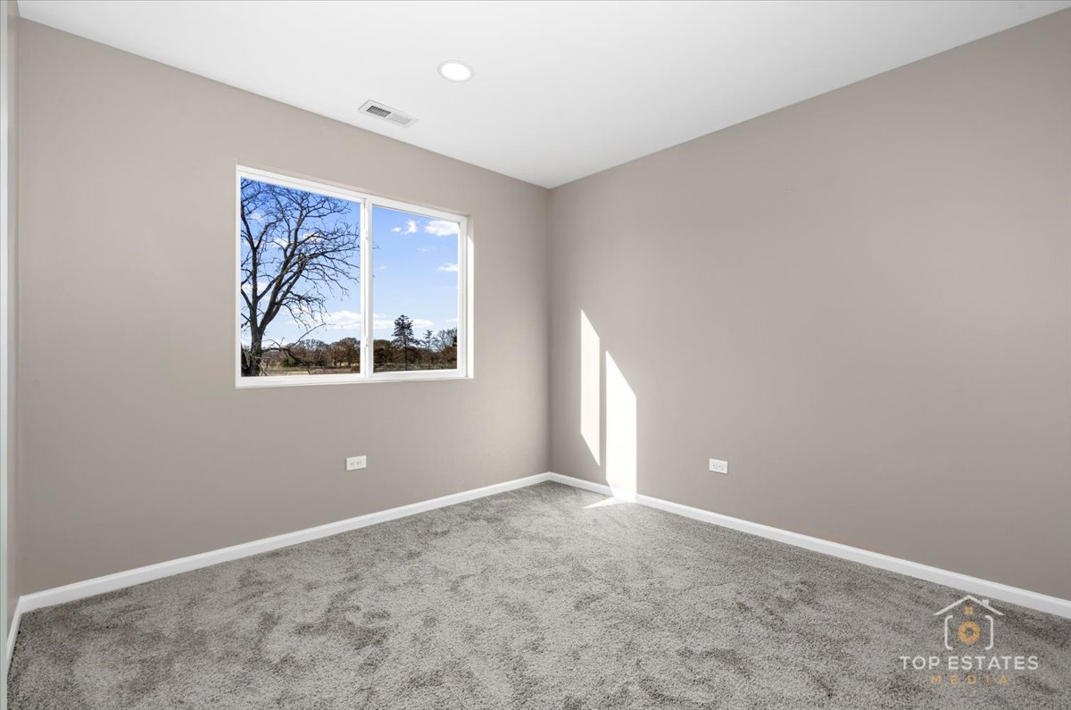 737 Springwood Drive Joliet, IL 60431 - Photo 17 of 31 an empty room with windows