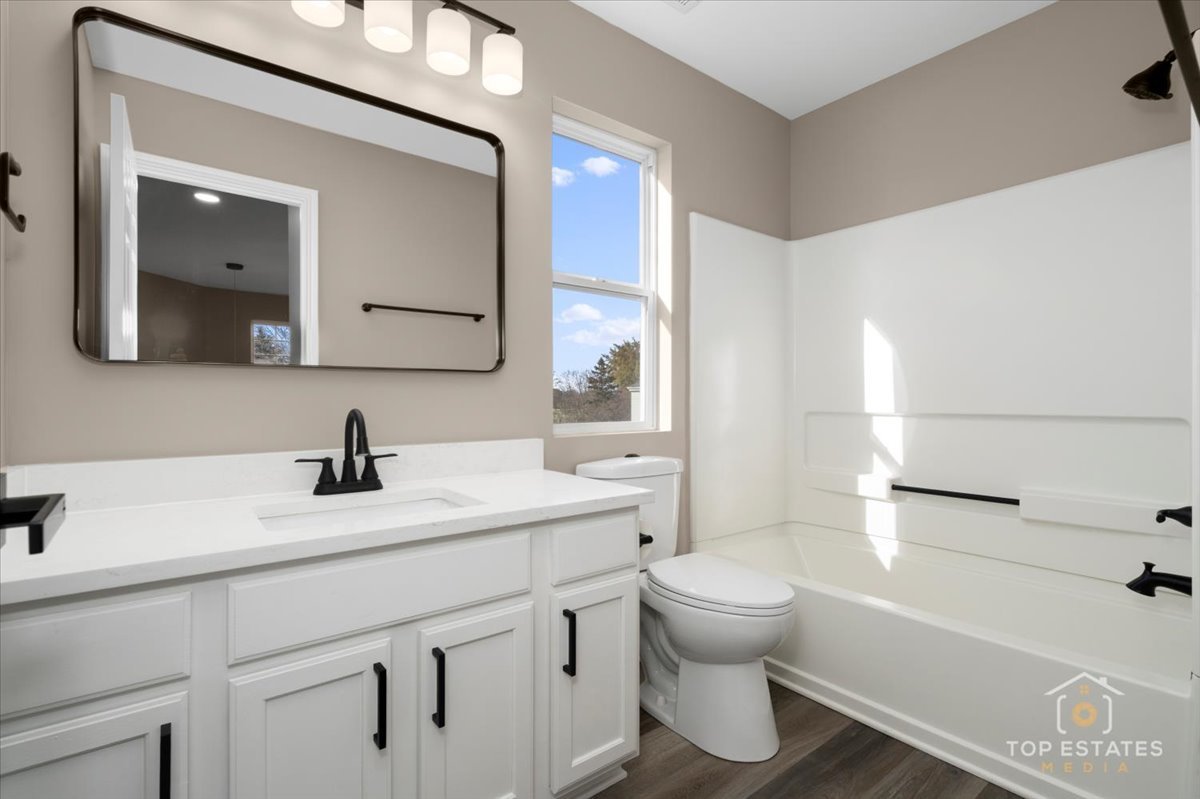 737 Springwood Drive Joliet, IL 60431 - Photo 20 of 31 a bathroom with a sink a toilet and a mirror