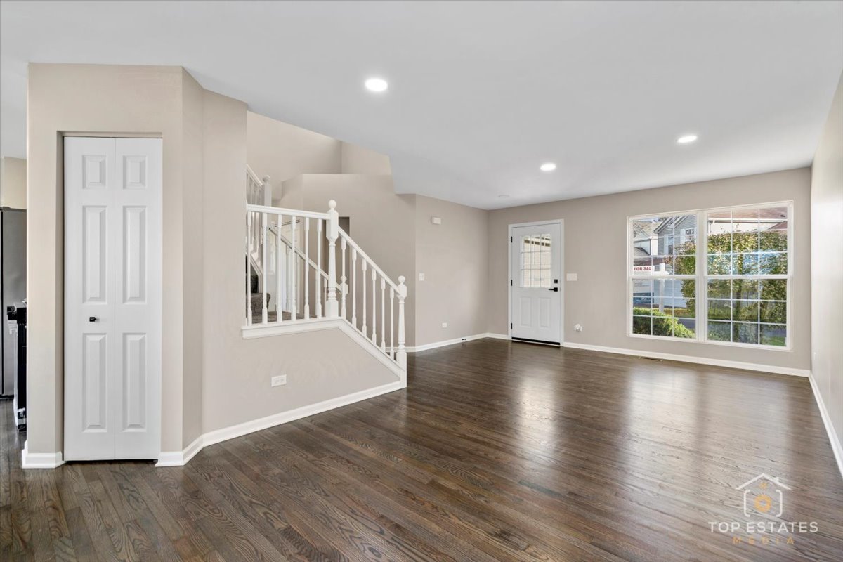 737 Springwood Drive Joliet, IL 60431 - Photo 4 of 31 a view of an empty room with wooden floor and a window