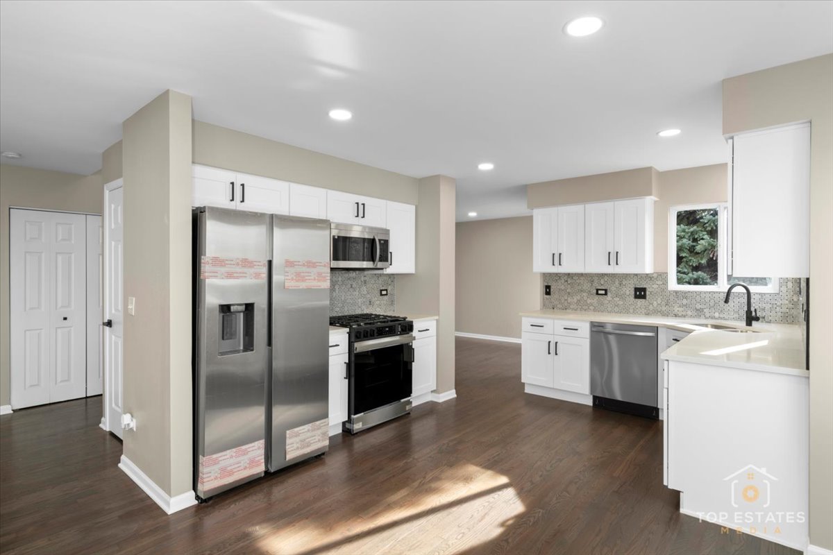 737 Springwood Drive Joliet, IL 60431 - Photo 8 of 31 a kitchen with a refrigerator sink and stove