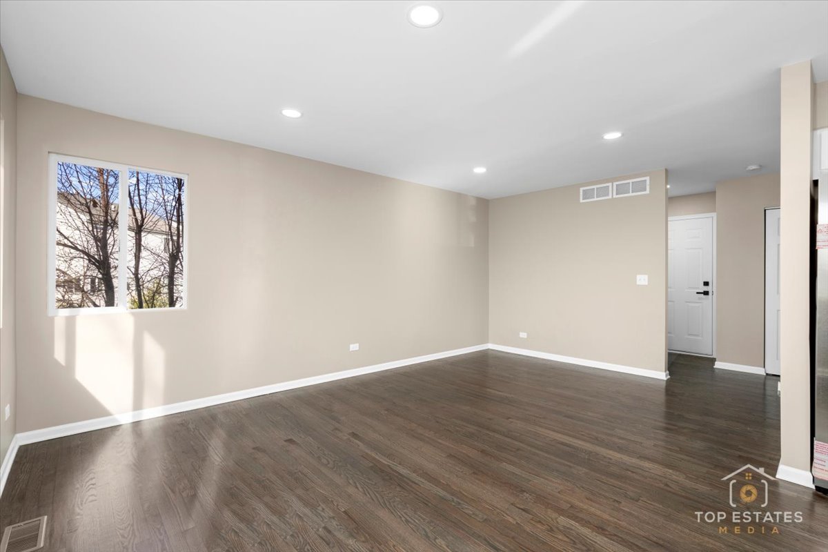 737 Springwood Drive Joliet, IL 60431 - Photo 10 of 31 a view of an empty room with wooden floor and a window