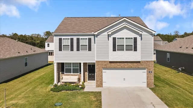 a front view of a house with a yard and garage