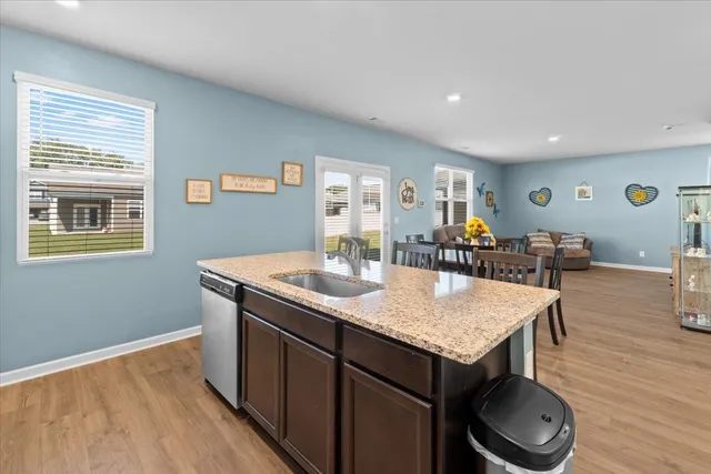 a view of kitchen island wooden cabinets and wooden floor