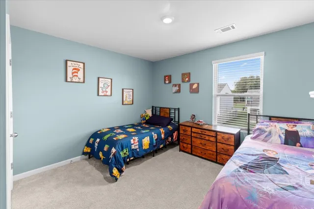 a bedroom with bed and a window