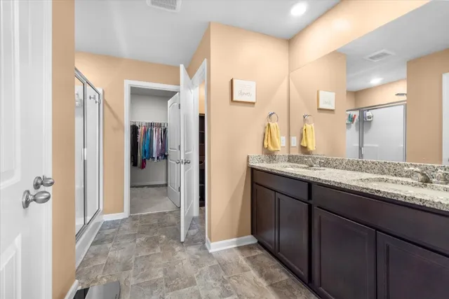 a bathroom with a glass shower door and a mirror
