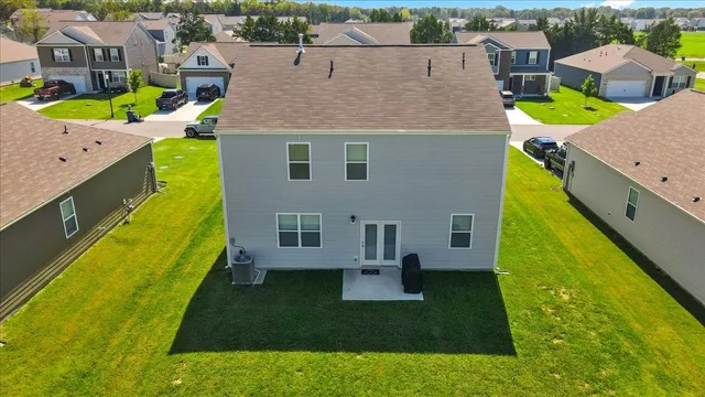 an aerial view of a residential houses with outdoor space
