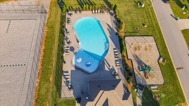 an aerial view of a backyard with swimming pool and outdoor seating