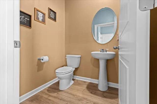 a bathroom with a toilet and a mirror
