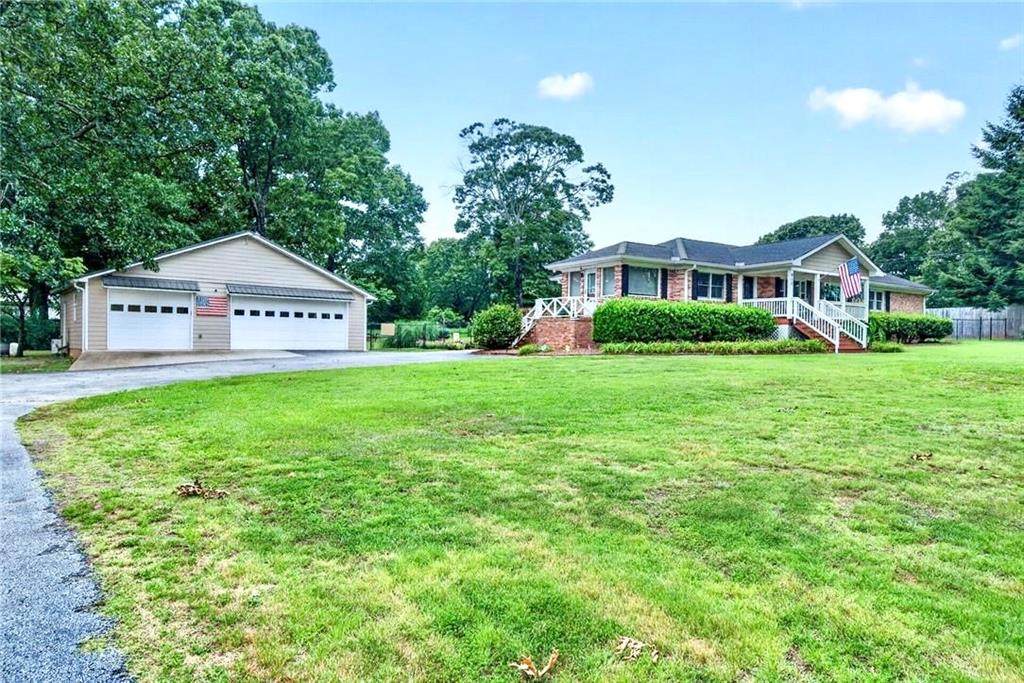 615 Tanner Road Dacula, GA 30019 - Photo 6 of 57 a front view of a house with a yard and trees