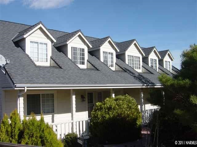2005 Shair Drive Reno, NV 89509 - Photo 1 of 1 a view of a large house with large windows and a yard with plants and palm trees
