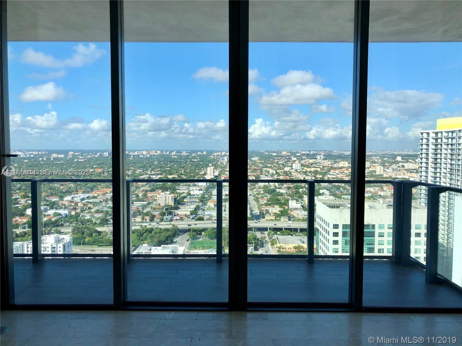 88 Southwest 7th Street, Unit 3610 Miami, FL 33130 - Photo 3 of 10 a view of an empty room and floor to ceiling window