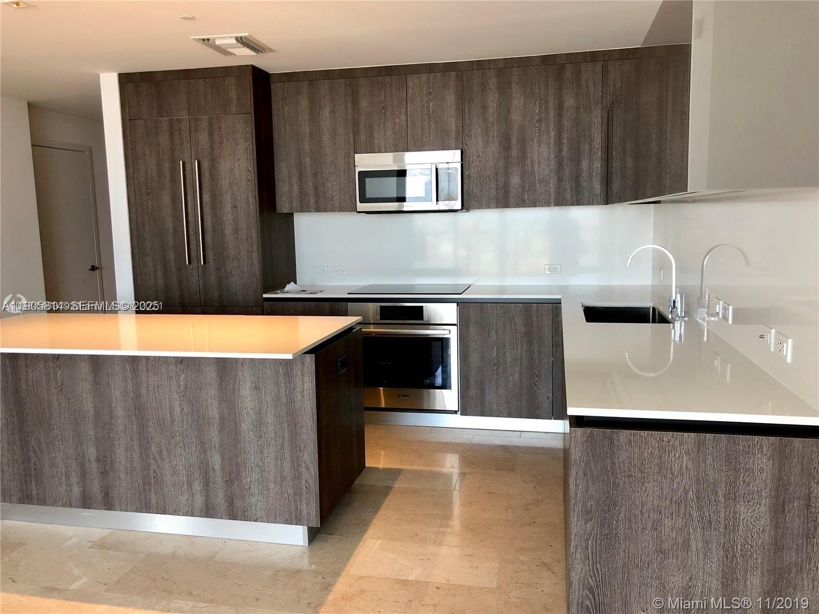 88 Southwest 7th Street, Unit 3610 Miami, FL 33130 - Photo 5 of 9 a kitchen with stainless steel appliances a refrigerator a sink a stove and a microwave