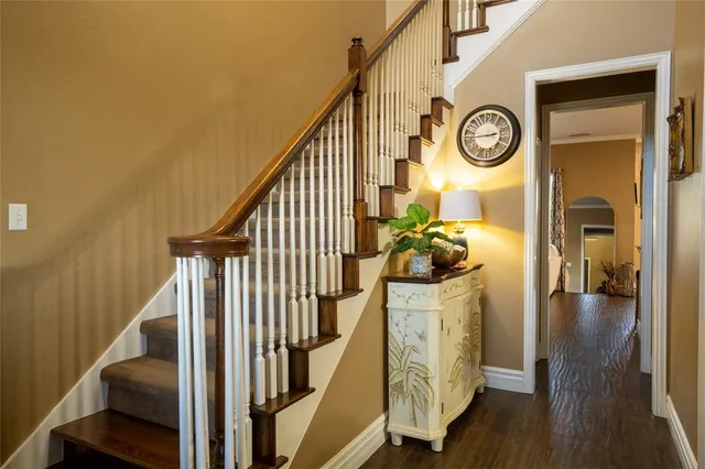 a view of a hallway with wooden floor and entryway