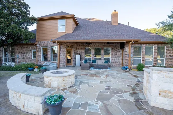 a view of a house with table and chairs in front of house