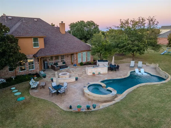 a view of a house with backyard outdoor seating and hardwood