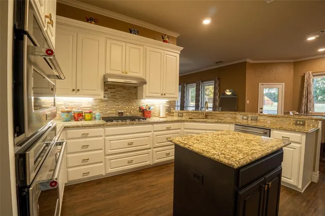 a kitchen with a stove a sink and a refrigerator