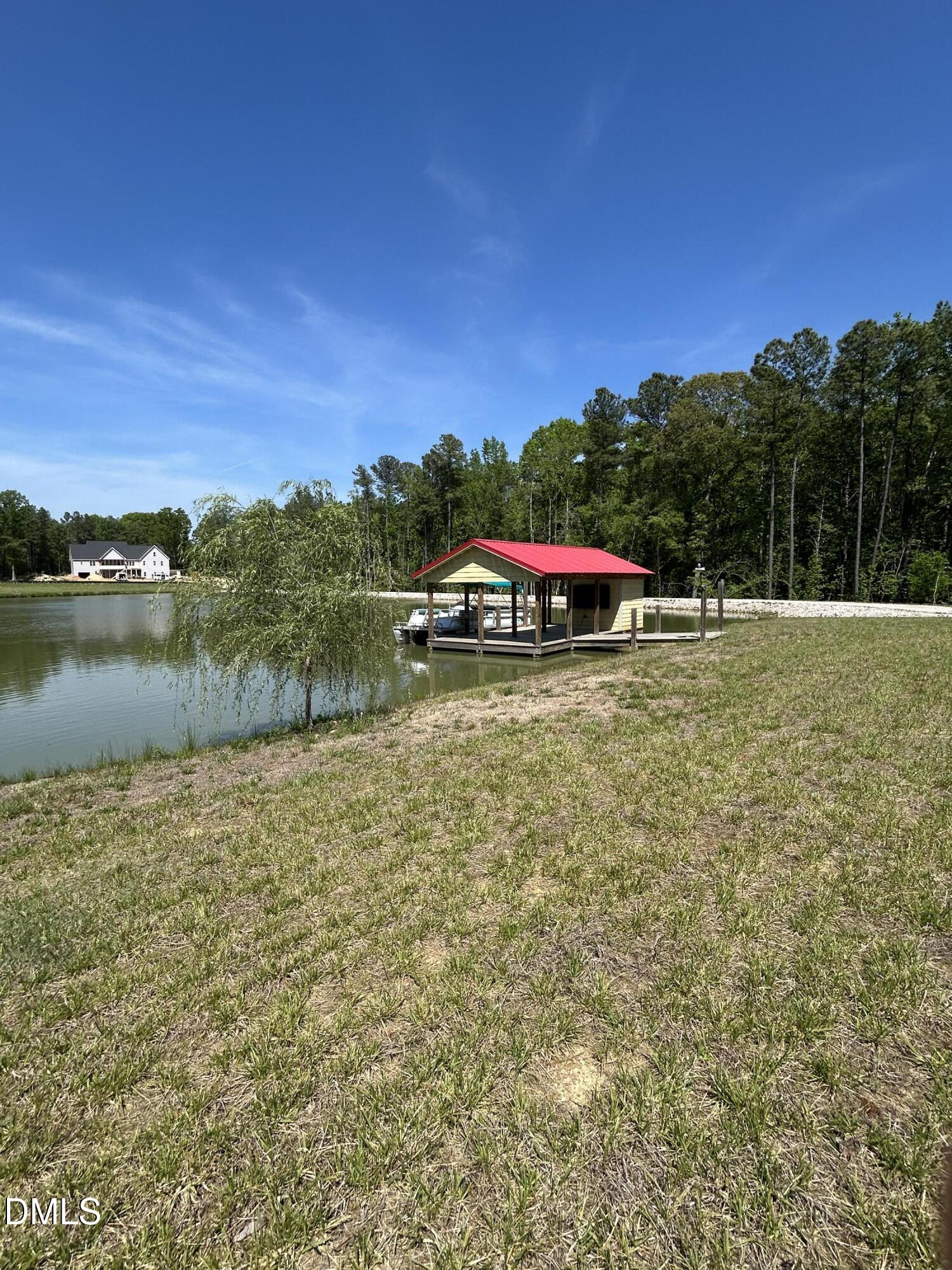 230 Bealy Farm Road Zebulon, NC 27597 - Photo 8 of 12 a view of a lake with houses
