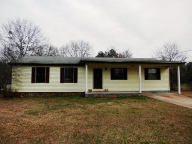 787 Gose Road Forsyth, GA 31029 - Photo 1 of 1 a view of a house with a large window and wooden fence