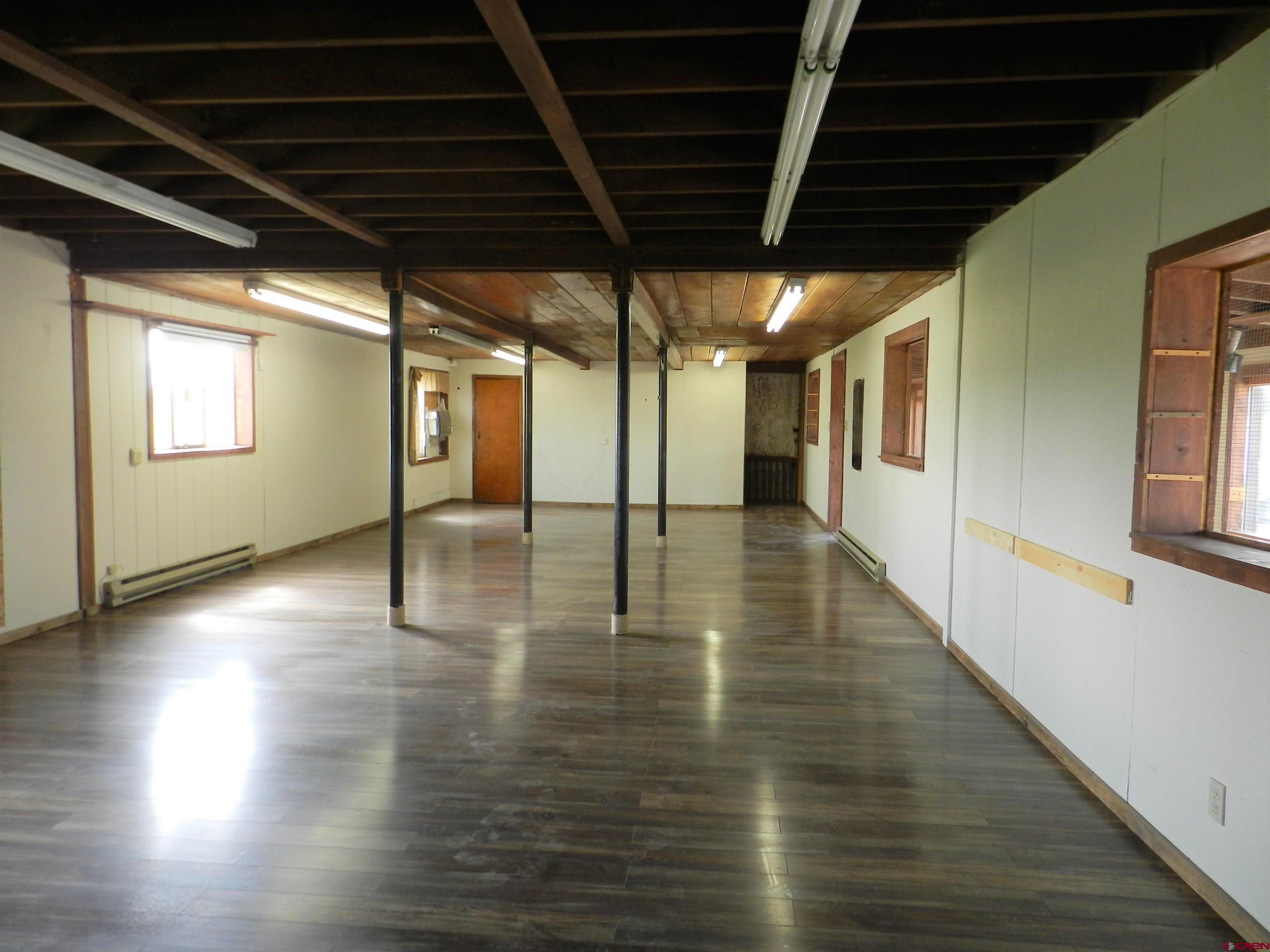 17656 Highway 550, Unit I1 Montrose, CO 81403 - Photo 11 of 18 a view of an empty room with wooden floor