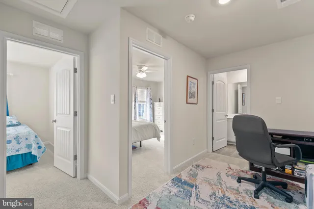 a bedroom with two beds and windows