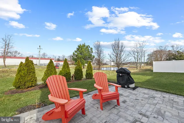 a view of a backyard with sitting area