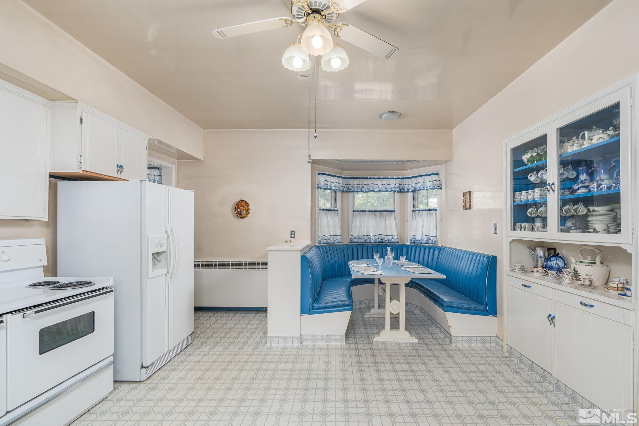 333 Urban Road Reno, NV 89509 - Photo 13 of 40 a kitchen with stainless steel appliances kitchen island granite countertop a refrigerator a sink dishwasher a dining table and chairs with wooden floor