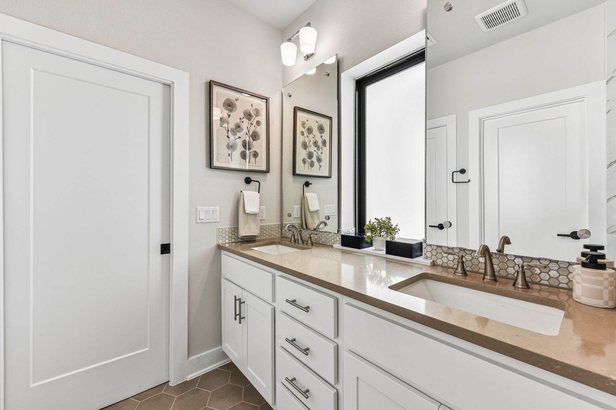 9101 Cattle Baron Path Austin, TX 78747 - Photo 25 of 40 Dual vanity with hexagonal tile backsplash and bright natural illumination.