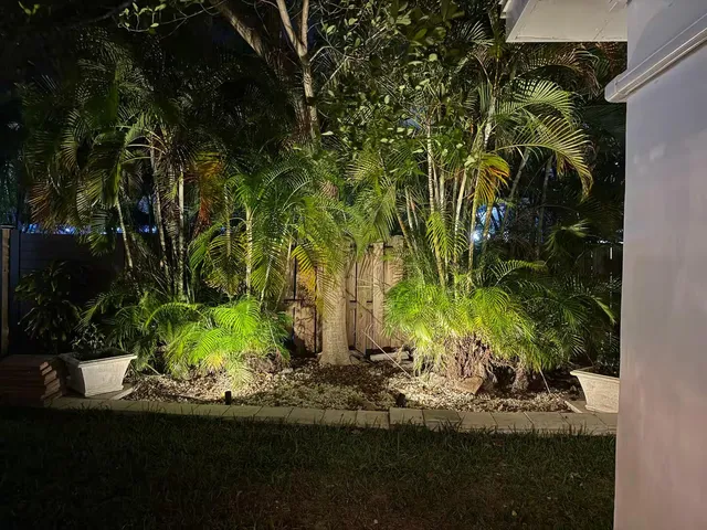 a view of a dining room with furniture a kitchen and a window