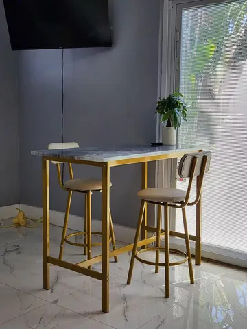 a kitchen with stainless steel appliances granite countertop a stove top oven a sink dishwasher and a microwave oven on the blue kitchen countertops