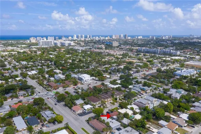 an aerial view of residential houses with city view