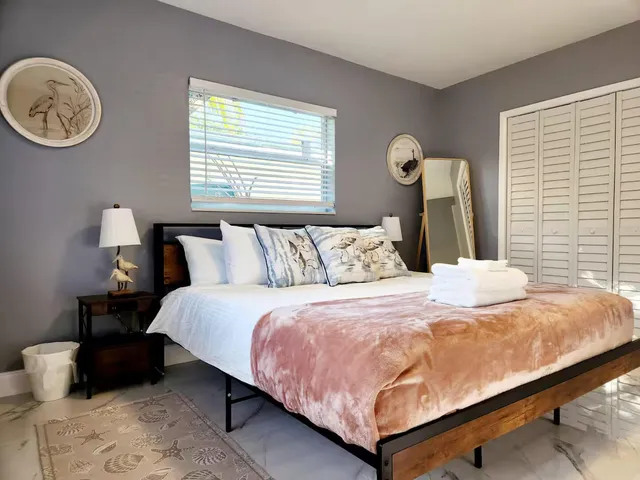 a bedroom with a bed and a lamp
