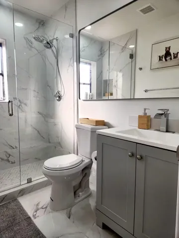 a bathroom with a sink toilet and shower