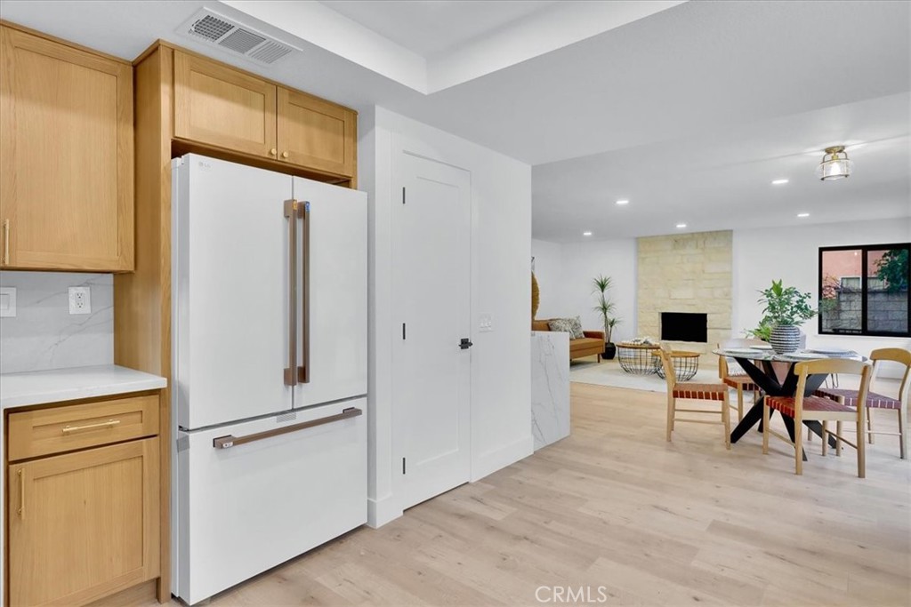 21029 Stoddard Wells Road Walnut, CA 91789 - Photo 11 of 34 a view of a kitchen with furniture and a refrigerator