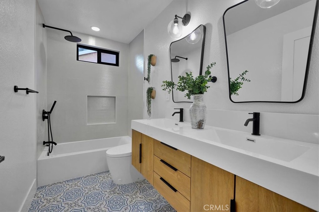21029 Stoddard Wells Road Walnut, CA 91789 - Photo 22 of 34 a bathroom with a tub sink toilet and mirror