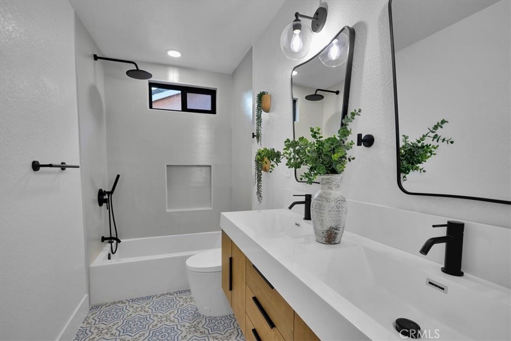 21029 Stoddard Wells Road Walnut, CA 91789 - Photo 23 of 34 a bathroom with a tub sink and mirror