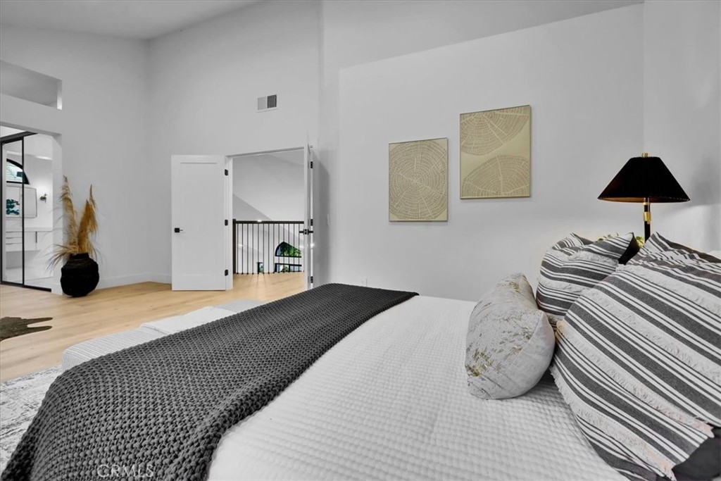 21029 Stoddard Wells Road Walnut, CA 91789 - Photo 26 of 34 a bedroom with a bed and a lamp