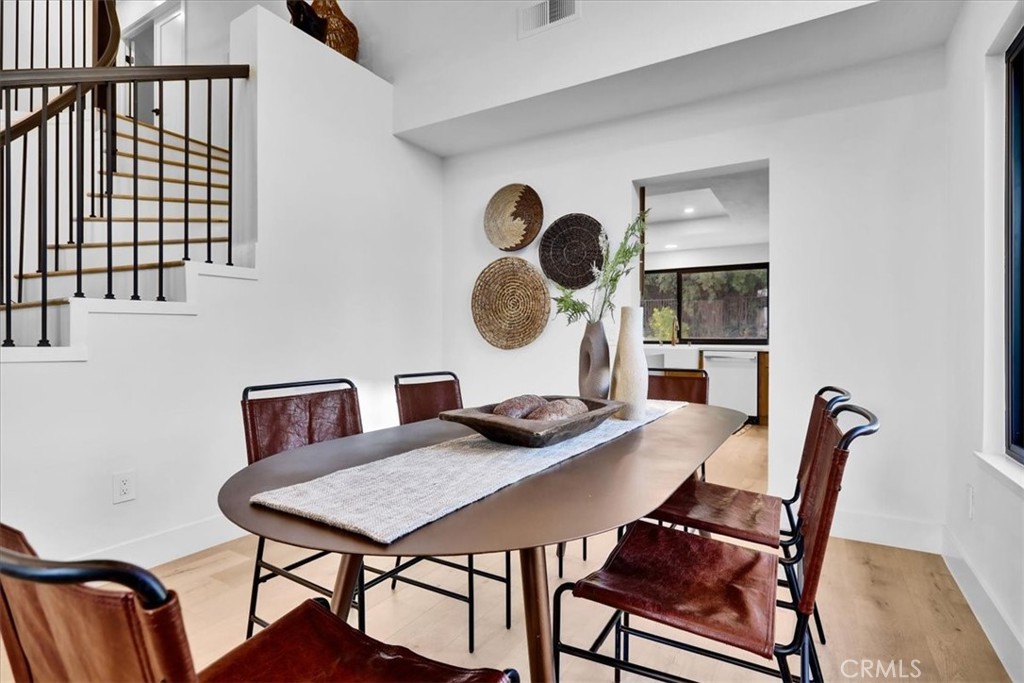 21029 Stoddard Wells Road Walnut, CA 91789 - Photo 8 of 34 a view of a dining room with furniture and wooden floor