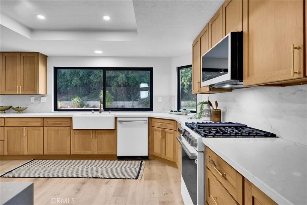 21029 Stoddard Wells Road Walnut, CA 91789 - Photo 9 of 34 a kitchen with stainless steel appliances granite countertop a stove a sink and a microwave