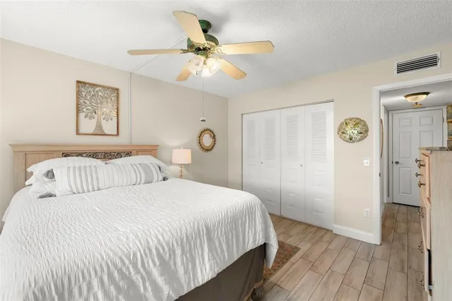 a bedroom with a large bed and a ceiling fan