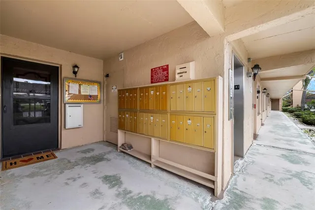 a view of a hallway with a refrigerator in wooden floor
