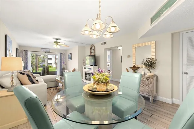 a view of a dining room with furniture and a chandelier