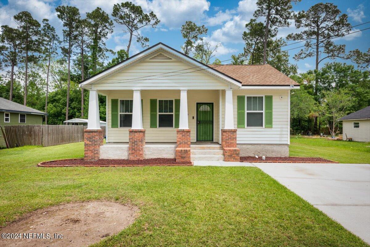 1953 Benedict Road Jacksonville, FL 32209 - Photo 1 of 23 a front view of a house with a yard table and chairs