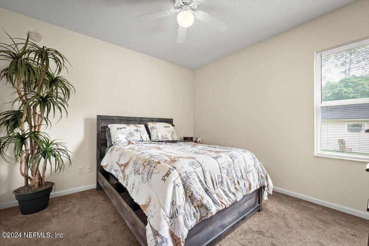 1953 Benedict Road Jacksonville, FL 32209 - Photo 18 of 23 a bedroom with a bed and a potted plant