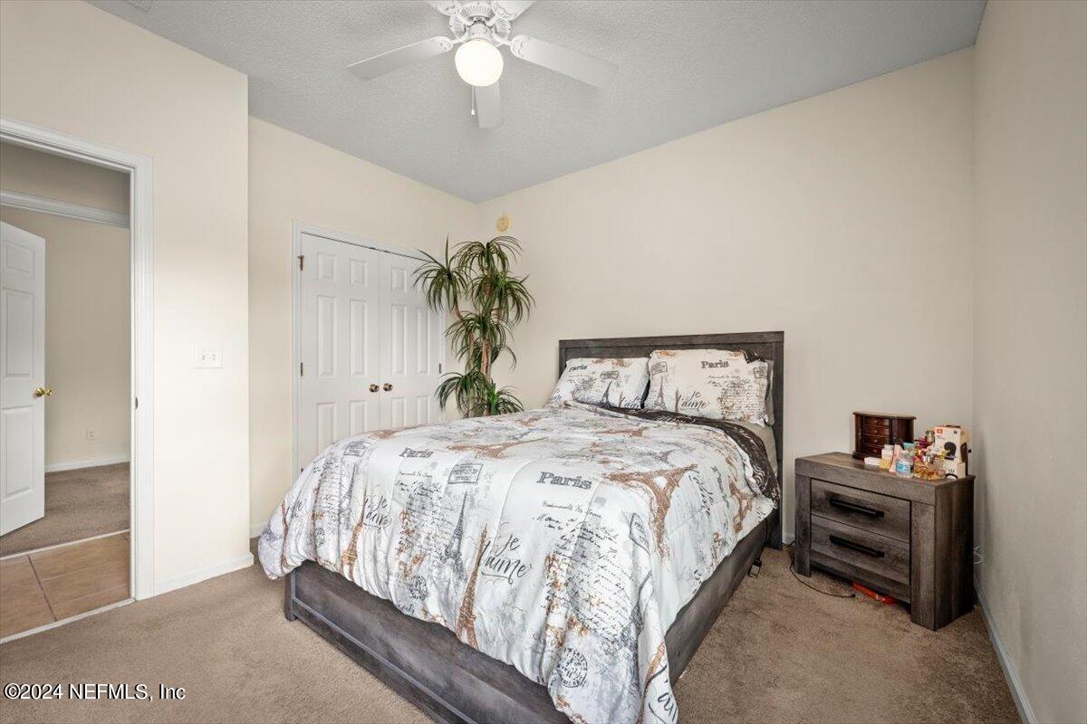1953 Benedict Road Jacksonville, FL 32209 - Photo 19 of 23 a bedroom with a bed and a chandelier