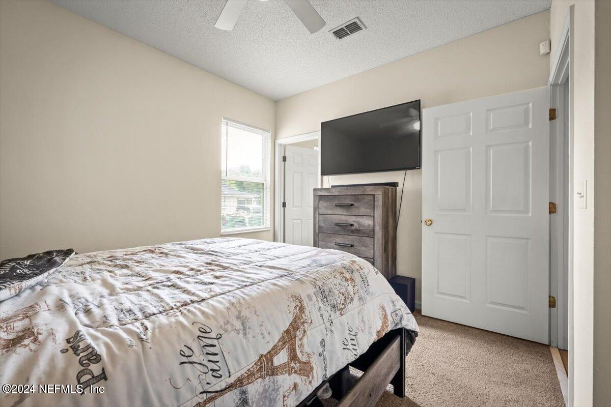 1953 Benedict Road Jacksonville, FL 32209 - Photo 20 of 23 a bedroom with a bed and a flat screen tv