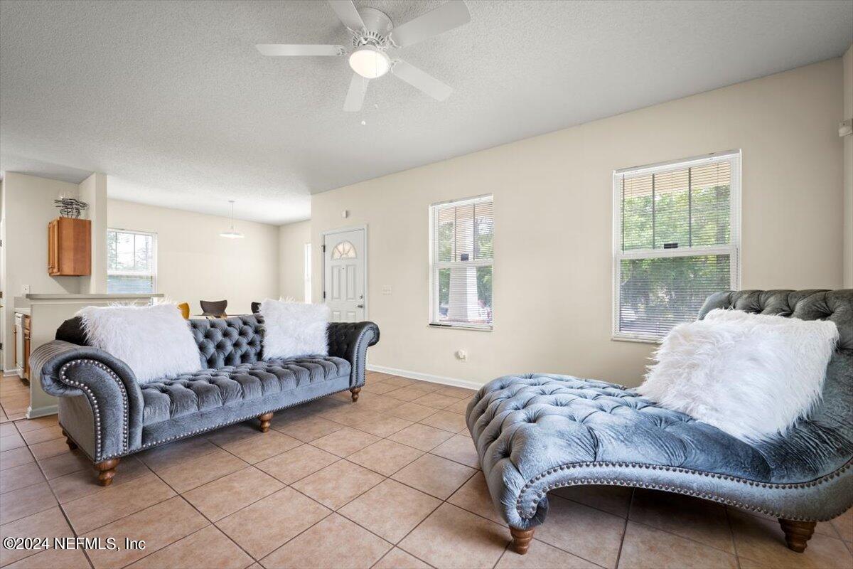 1953 Benedict Road Jacksonville, FL 32209 - Photo 4 of 23 a bedroom with a large bed and a couch