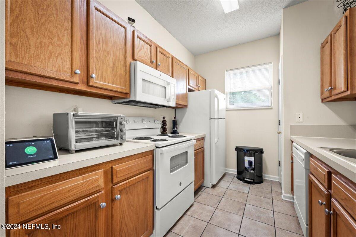1953 Benedict Road Jacksonville, FL 32209 - Photo 8 of 23 a kitchen with stainless steel appliances granite countertop a refrigerator sink and stove