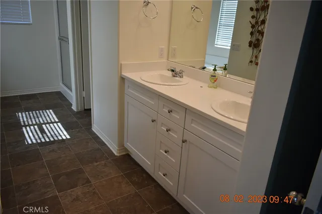 a bathroom with a sink a mirror and a shower