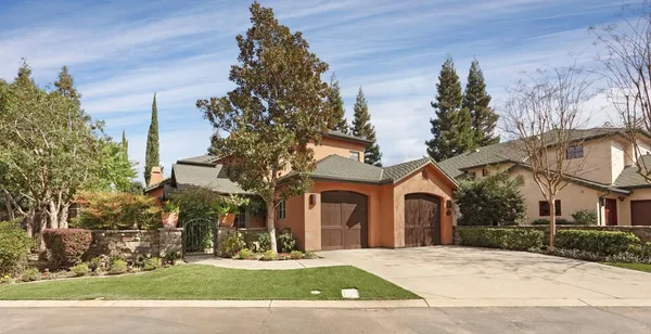 a front view of a house with yard and green space