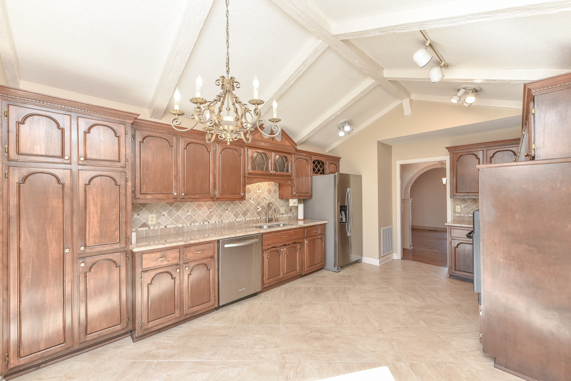 450 Bell Road Gallatin, TN 37066 - Photo 11 of 45 a bathroom with a granite countertop sink a refrigerator and a chandelier
